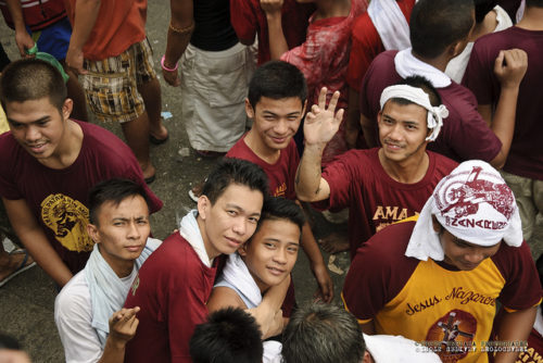 Devotees of the Black Nazarene wave at the camera during the yearly procession in 2011. THOTS URPIANA