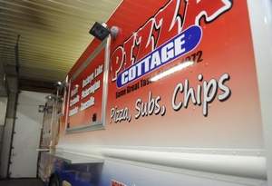 The new Pizza Cottage food truck has its own generator for electricity, a water tank and stations to prepare subs and pizzas. / Jess Lanning/Eagle-Gazette