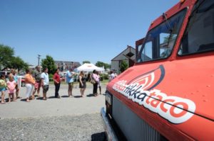 Hungry customers wait in line at the Tikka Tikka Taco truck at the Annapolis Yacht Club’s annex. Three competing trucks from Food Network’s “The Great Food Truck Race” stopped in Annapolis Friday afternoon. See more photos online at capitalgazette.com.