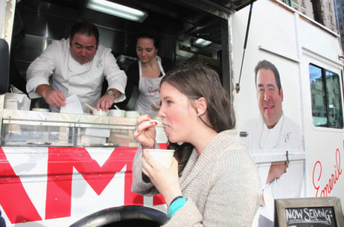 In this file photo, Emeril Lagasse serves Gumbo from a food truck to guests before he Launches New High-Performance Kitchen Collection at Greeley Square Park on April 4, 2012 in New York City.