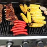 Some barbecue fare cooks on one of several grills at Moose’s Mobile Kitchen.