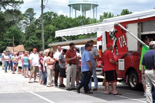 Photo by Tamika Galanis: Hampton residents waiting in line at The Varsity food truck at Moye’s Pharmacy’s customer appreciation event.