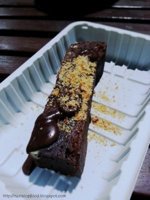 Organic Spelt Chocolate Brownie (Organic spelt chocolate brownie, almond praline, chocolate sauce) $8