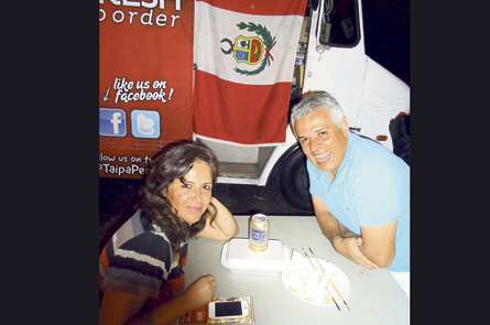 Happy customers of Taipa Peruvian Fast Food Truck, Nelly and Enrique Doria, follow their Peruvian flag (in background) and Peruvian food anywhere they can. 