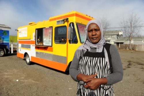 Omima Adams, formerly from Sudan, poses in front of her Sultan Shawarma food truck  at 4055 Mountain View Drive in Anchorage, AK on Tuesday, March 31, 2015.