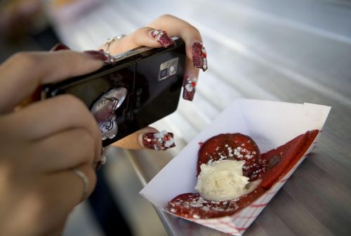 A customer photographs her Buttermilk Truck red velvet chocolate chip pancake. Anne Fishbein