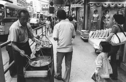 A street vendor sells stinky tofu from a cart.