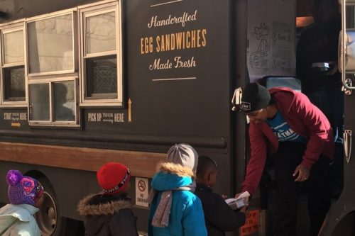 Eastman Egg Company's Keisha Jackson serves snacks to Ray Elementary students.  [DNAinfo/Janet Rausa Fuller]
