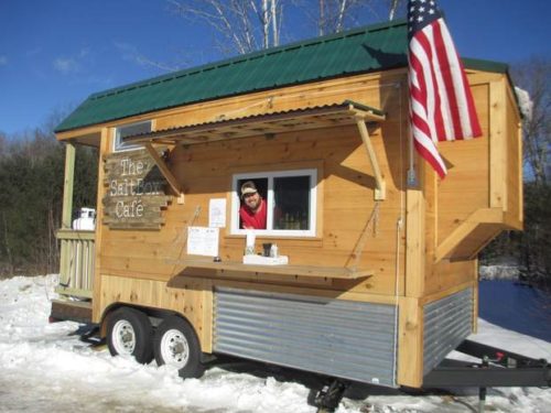 Matthew Glatz entices passing skiers from The SaltBox Cafe, open Thursday through Monday, on Sunday River Road in Newry.