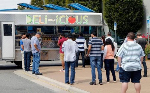 Diners line up as the food truck Deli-icious serves customers  at Qualcomm’s corporate offices in RTP in 2015. Food  truck regulations across the Triangle vary by town and city.  Chris Seward cseward@newsobserver.com