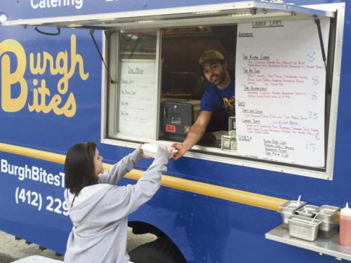 David Mayernik Jr. | Tribune-Review Samantha Lorentz, 19, of Moon, purchases food from Ricci Minella’s Burgh Bites truck at the first “Food Truck Friday” of the summer in Heidelberg on May 20.