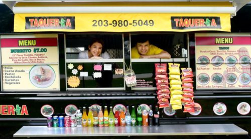 (Peter Hvizdak - New Haven Register) Employee Janina Torres (CQ),left, and owner Beto Carvente of the mexican food truck Taqueria Cinco, on the corner of Broad Street and Church Street in Guilford Thursday, May 19, 2016.