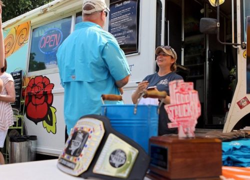 Patrick Johnston/Times Record News Tagan Couch, owner of the Gypsy Kit, right, takes an order from a customer Saturday afternoon. The truck, which is from Wichita Falls and was named the Grand Champion in 2015, was one of 40 to compete in the second annual Food Truck Championship of Texas in Graham.